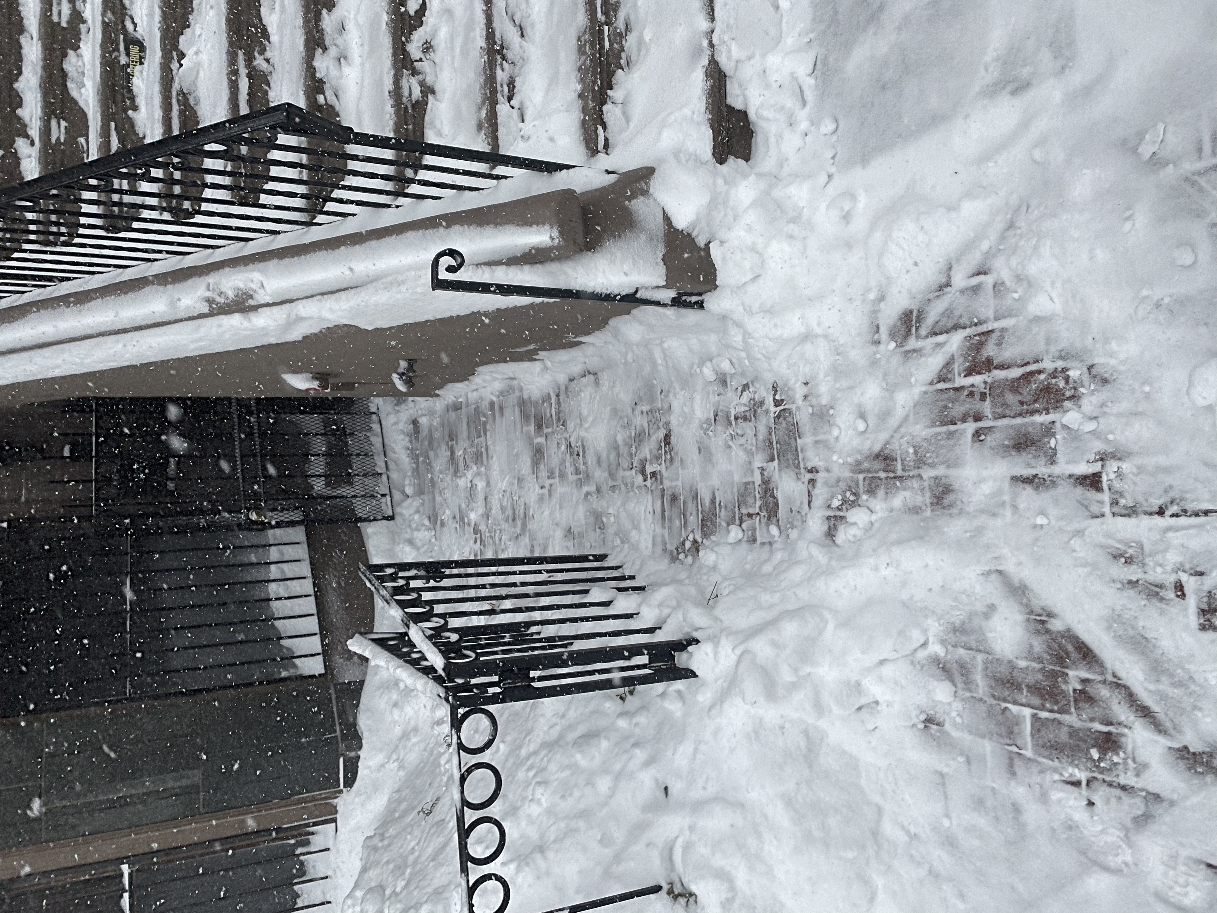 A Boston walkway and stoop taken back down to the brick during that same January 2022 storm.
