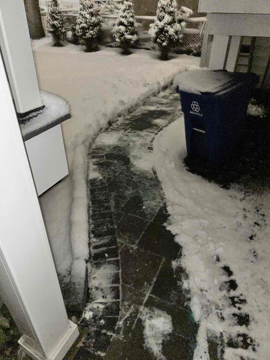 A brick walkway in Arlington, cut clean through to the pavement with the snow banked on both sides — our crew’s own after photo, timestamped 5:15 AM on January 19, 2026.